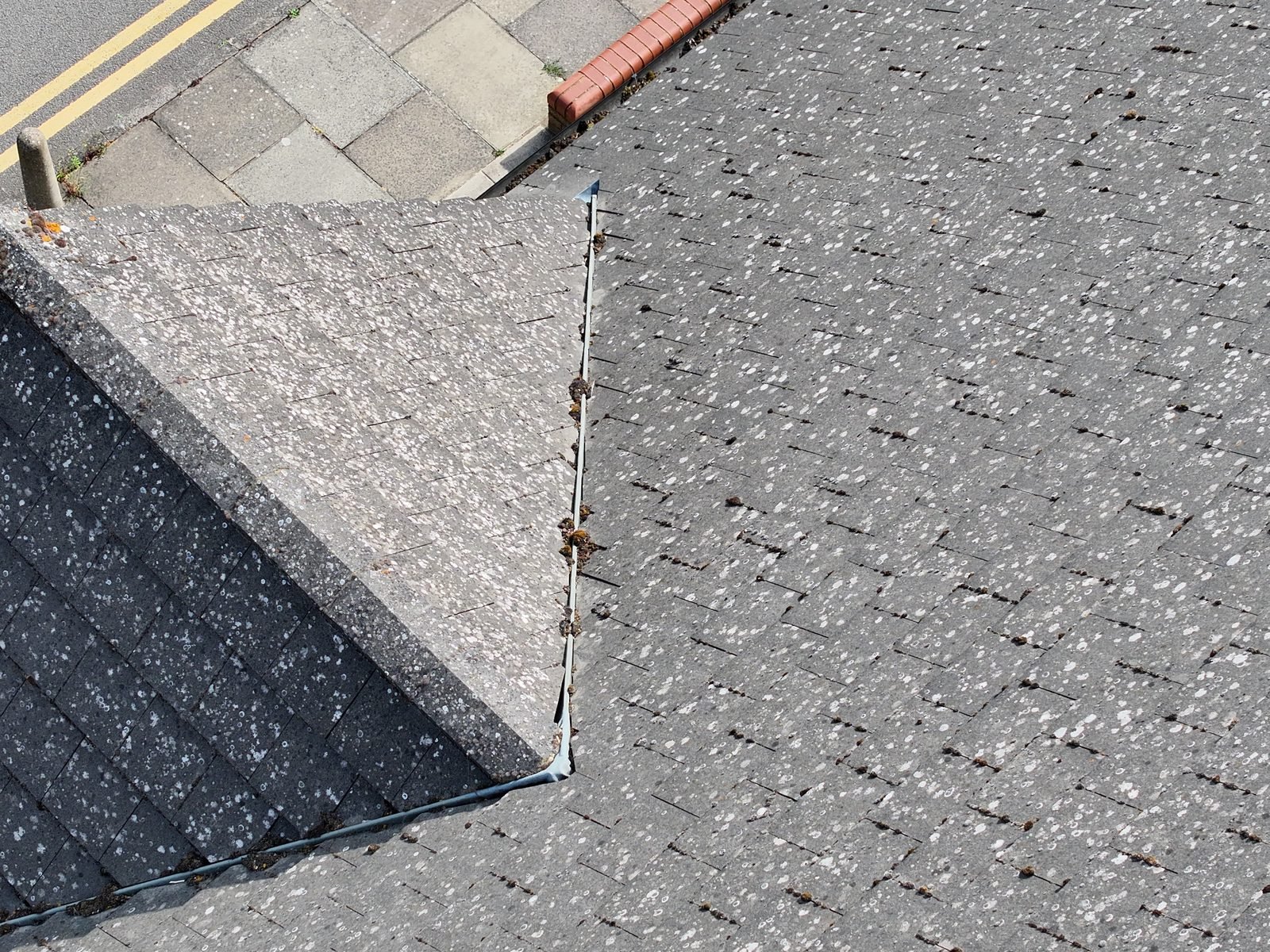 Drone photograph across the hipped tiled roof of Whaddon Way Church, Bletchley, with a rooflight strip and the road beyond